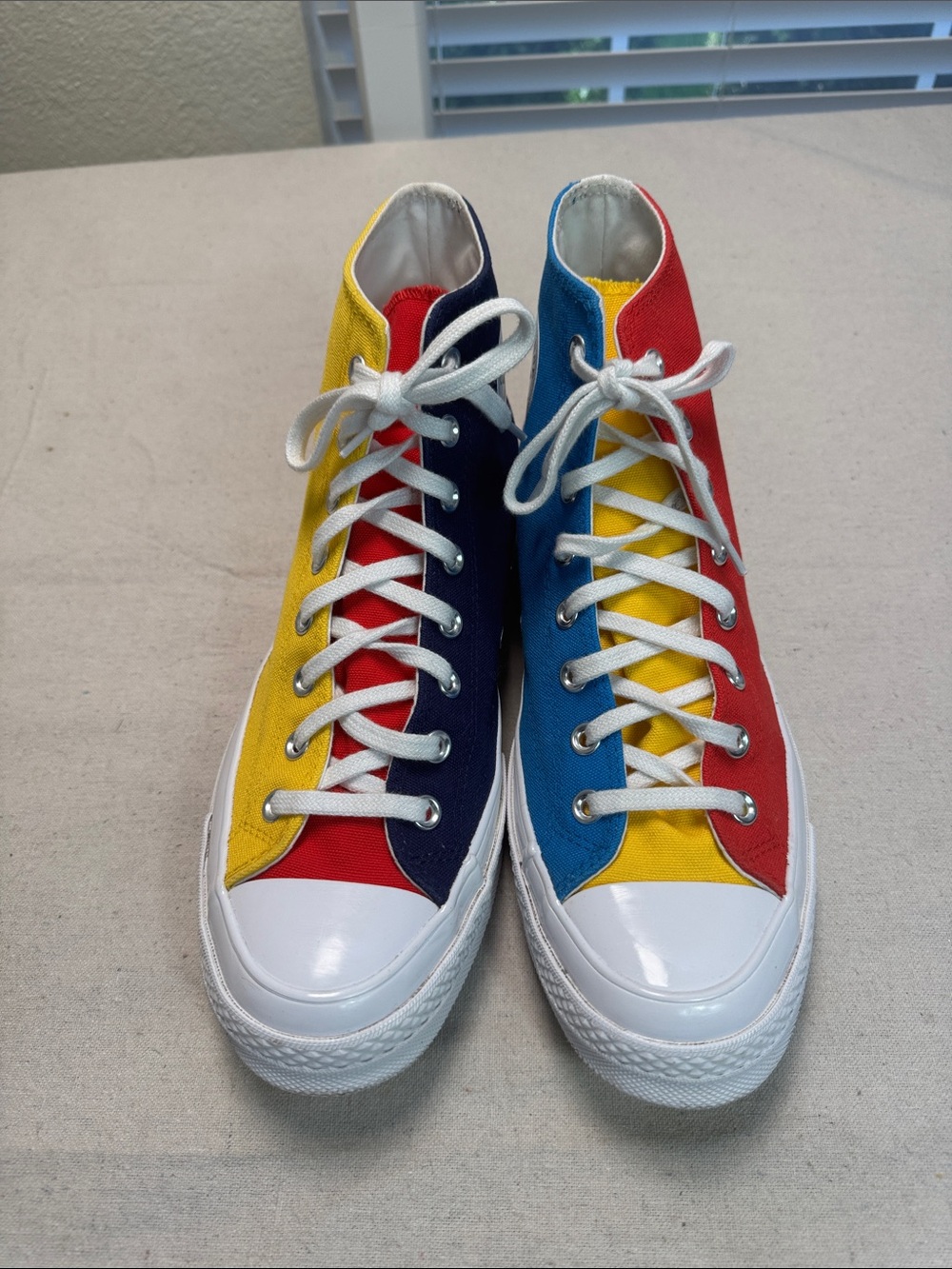 Converse All Star Chuck Golf Wang High Top Sneakers in Yellow, Blue, and Red.